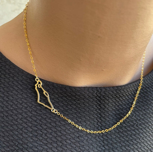 A gold-filled necklace featuring a Israel map charm, displayed on a person's neck.