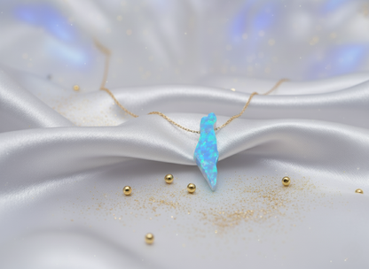 Opal necklace on a white satin surface with gold beads