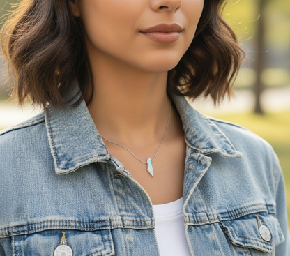Woman wearing a denim jacket with a blurred outdoor background